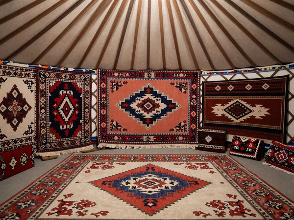 Traditional Kyrgyz yurt interior with colorful shyrdak felt carpets